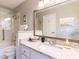 Main bathroom with a shower/tub combo, granite vanity and large mirror at 1018 Caravel Ct, Tarpon Springs, FL 34689