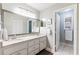 Double vanity bathroom with granite countertops and a large mirror at 1018 Caravel Ct, Tarpon Springs, FL 34689