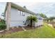 Home's exterior showcasing a deck and landscaping at 1018 Caravel Ct, Tarpon Springs, FL 34689