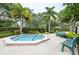 Relaxing community hot tub with benches nearby at 1018 Caravel Ct, Tarpon Springs, FL 34689