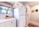 White kitchen with stainless steel appliances and a view of the exterior at 1018 Caravel Ct, Tarpon Springs, FL 34689