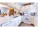 Bright kitchen with white cabinets, quartz countertops, and stainless steel appliances at 1018 Caravel Ct, Tarpon Springs, FL 34689