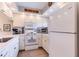 White kitchen features stainless steel appliances and ample counter space at 1018 Caravel Ct, Tarpon Springs, FL 34689