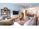 Open living room with leather sofas, built-in shelving, and a view into the dining area at 1018 Caravel Ct, Tarpon Springs, FL 34689