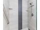 Large walk-in shower with gray tile and a built-in seat at 1018 Caravel Ct, Tarpon Springs, FL 34689