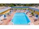 Community swimming pool with surrounding lounge chairs and umbrellas at 103 E Saint Lucia Loop, Apollo Beach, FL 33572