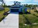 New construction home with a large yard and driveway at 105 Oakwood Ct, Rotonda West, FL 33947