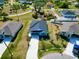 New house with driveway and landscaping, aerial view of neighborhood at 105 Oakwood Ct, Rotonda West, FL 33947