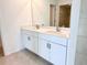 Double sink bathroom vanity with white cabinets and quartz countertop at 105 Oakwood Ct, Rotonda West, FL 33947