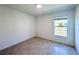 Simple bedroom with tile floors and a window at 105 Oakwood Ct, Rotonda West, FL 33947