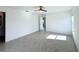 Well-lit bedroom with tile floors and access to another room at 105 Oakwood Ct, Rotonda West, FL 33947