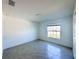 Bright bedroom with tile floors and a large window at 105 Oakwood Ct, Rotonda West, FL 33947