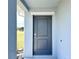 Dark gray front door with a keypad lock at 105 Oakwood Ct, Rotonda West, FL 33947