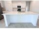 White kitchen island with a quartz countertop and storage at 105 Oakwood Ct, Rotonda West, FL 33947