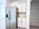 Kitchen with stainless steel refrigerator and pantry at 105 Oakwood Ct, Rotonda West, FL 33947