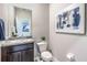 Powder room with single vanity and dark wood cabinet at 10535 Bridgegate Heights Loop, San Antonio, FL 33576