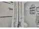 Bathroom with shower, toilet and nautical decor at 10581 Pine Island Dr, Weeki Wachee, FL 34607