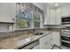 Kitchen boasts granite countertops and modern sink at 10581 Pine Island Dr, Weeki Wachee, FL 34607