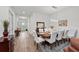 Elegant dining room features a wood table with white chairs, and views of the entryway at 10804 Wicker Park Pl, Palmetto, FL 34221