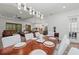 Bright dining room with a large wooden table and white chairs, offering views into the living area and kitchen at 10804 Wicker Park Pl, Palmetto, FL 34221