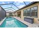 Relaxing pool and spa area with covered patio and outdoor seating at 10804 Wicker Park Pl, Palmetto, FL 34221