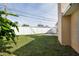 Grass backyard with a white fence and small patio at 10821 Freedom Blvd, Seminole, FL 33772