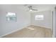 Bright bedroom with two windows, ceiling fan, and wood-look floors at 10821 Freedom Blvd, Seminole, FL 33772