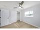 Bedroom with ceiling fan, closet, and window with blinds at 10821 Freedom Blvd, Seminole, FL 33772