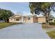 Front of house with driveway and landscaping at 10821 Freedom Blvd, Seminole, FL 33772