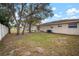 Large backyard with mature trees and a partially fenced area at 1203 Baronwood Pl, Brandon, FL 33510