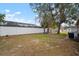 Large backyard with mature trees and a privacy fence at 1203 Baronwood Pl, Brandon, FL 33510