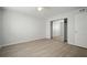 Bright bedroom with mirrored closet doors and wood-look floors at 1203 Baronwood Pl, Brandon, FL 33510