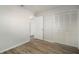 Bedroom with wood-look floors and mirrored closet doors at 1203 Baronwood Pl, Brandon, FL 33510