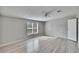 Sunlit bedroom with gray walls, wood-look floors and ceiling fan at 12914 Gordon Rd, Riverview, FL 33579