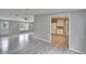 View into kitchen with white cabinets and gray flooring from living room at 12914 Gordon Rd, Riverview, FL 33579