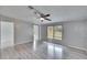 Bright living room featuring wood-look floors and a large window at 12914 Gordon Rd, Riverview, FL 33579