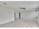 Living room with ceiling fan, gray walls, and wood-look flooring at 12914 Gordon Rd, Riverview, FL 33579