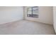 Well-lit bedroom with neutral carpeting and large window at 1311 Powderpuff Dr # 4, Dunedin, FL 34698