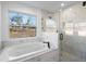 Luxurious bathroom with soaking tub and marble shower at 13145 Flotilla Ct, Brooksville, FL 34613