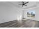 Sunlit bedroom showcasing wood-look floors and a ceiling fan at 13145 Flotilla Ct, Brooksville, FL 34613