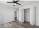 Bright bedroom with wood-look floors and ceiling fan at 13145 Flotilla Ct, Brooksville, FL 34613