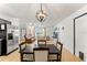 Dining area with four chairs, light wood floors, and kitchen view at 13178 Thrush St, Spring Hill, FL 34609