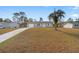 Single story house with a gray exterior, white shutters, and a palm tree at 13178 Thrush St, Spring Hill, FL 34609