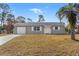 Updated single-story house with a gray exterior, white shutters, and a well-maintained lawn at 13178 Thrush St, Spring Hill, FL 34609