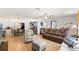 Living room with brown leather couches, a TV, and hardwood floors at 13178 Thrush St, Spring Hill, FL 34609