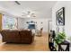 Living room with brown leather couches, a TV, and hardwood floors at 13178 Thrush St, Spring Hill, FL 34609