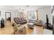 Living room with brown leather couches, a TV, and hardwood floors at 13178 Thrush St, Spring Hill, FL 34609