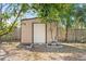 Tan storage shed nestled in the backyard at 13178 Thrush St, Spring Hill, FL 34609