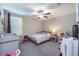 Charming bedroom with a pink bed frame and plenty of space at 13614 Wild Ginger St, Riverview, FL 33579