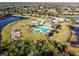 Aerial view of community pool, playground, and surrounding landscape at 13614 Wild Ginger St, Riverview, FL 33579